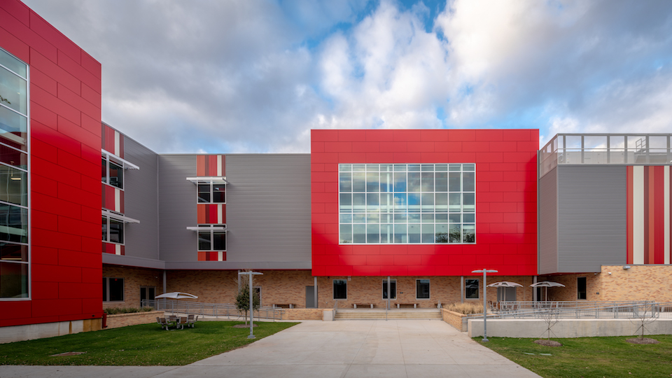 building with red and gray metal panels